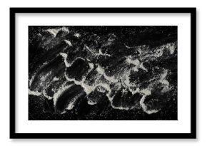 Pile of integral barley flour isolated on black background, top view 