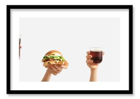 Female hands with tasty burger, french fries and glasses of cola on white background