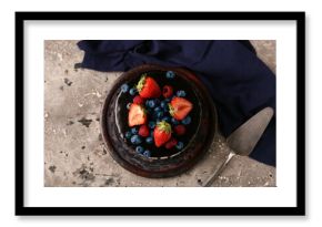 Sweet chocolate cake with fresh berries on grey background