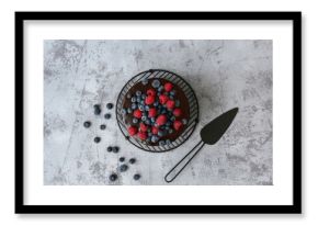Sweet chocolate cake with fresh berries on grey background