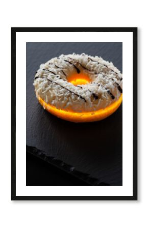 Dramatic Backlit Coconut Donut Glowing on Dark Black Slate Surface