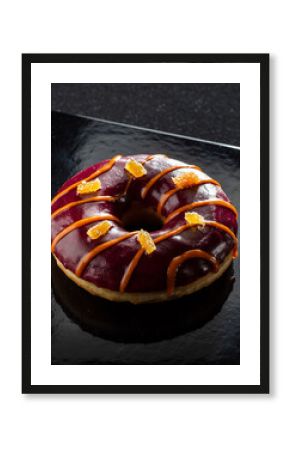 Deep Purple Glazed Donut with Candied Ginger on Black Plate