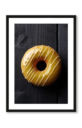 Mustard Yellow Glazed Donut with White Drizzle on Dark Wooden Planks
