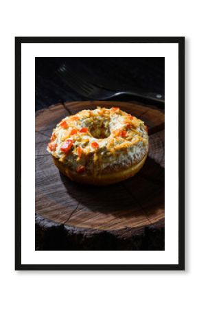 Gourmet Savory Donut with Creamy Topping and Chili Flakes on Wood Slice