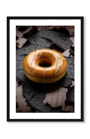 Dramatic Caramel Glazed Donut on Textured, Charred and Burnt Wooden Surface