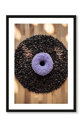 Purple Donut Centered on Pattern of Dark Roasted Coffee Beans and Wood