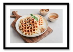 Homemade waffles with topping of honey, walnut and banana