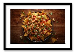 High angle shot of chicken tortilla nachos topped with cream sauce, designed for culinary display
