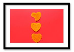 Tasty nuggets in shape of heart on red background. Valentine's Day celebration