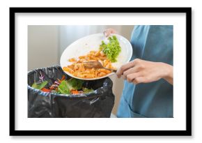 Compost from leftover food asian young housekeeper woman, girl hand holding macaroni plate use fork throw away food scraps, rotten vegetable into trash. Environmentally responsible, food waste concept