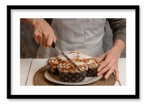 male chef holding christmas colomba cake against grey wall