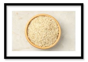 Brown rice in bowl on light grey table, top view