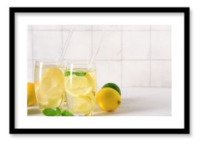 Glasses of tasty lemonade with mint on white table