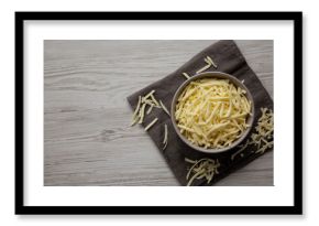 Shredded Mozzarella Cheese in a Bowl, top view. Copy space.