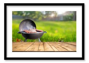 summer time in backyard garden with grill BBQ, wooden table, blurred background