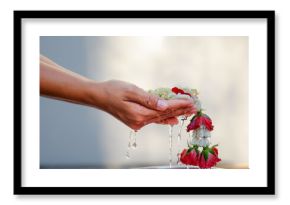Hand of young woman pour water and flowers on the hands. older women and happy for the songkran festival. concept gives blessing in Songkran day Thailand