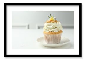 Tasty Easter cupcake with vanilla cream on white table, space for text