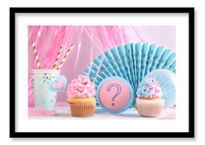 Delicious cupcakes with question mark and decorations on table against white background. Gender reveal party concept