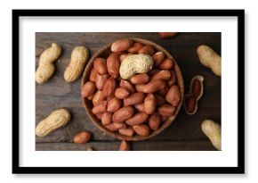 Fresh peanuts in bowl on wooden table, flat lay
