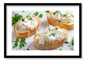 Slices of bread with cream cheese and herbs