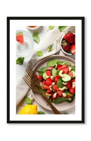 Fresh watermelon salad in a bowl with lemon and strawberries on the table