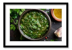 Top view of a healthy condiment recipe fresh salsa verde in a bowl with a green sauce made from fresh herbs spices and a chimichurri dipping sauce created with