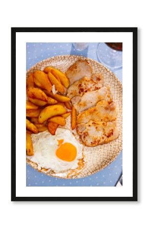 Plate with prepared food pork chop with potatoes and fried egg