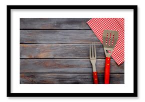 Set with barbecue utensils and equipment with red picnic napkin. Stainless steel tools. Top view