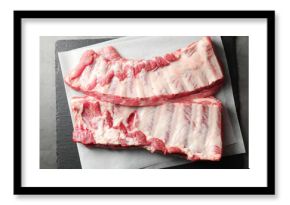 Raw pork ribs on grey table, top view