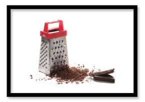 Kitchen grater and pile chopped, dark chocolate isolated on white background