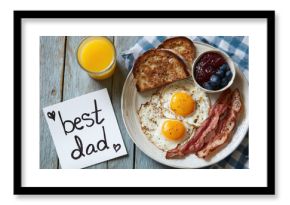 overhead view of a fathers day breakfast with a hand drawn card on table
