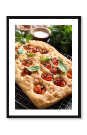 Delicious focaccia with tomatoes and spices on table, closeup