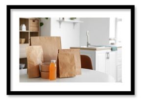 Paper bags with juice on table in room. Food delivery service