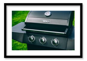 Barbecue gas grill in stainless steel. Black modern stainless portable BBQ barbecue grill outdoor.