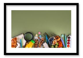 School healthy food for children. Preparing homemade balanced healthy lunch box for schooler, with sandwich, fruits, berries, juice, nuts. Ingredients and foods with school stationery and utensils