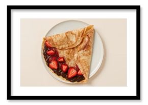 Sweet treat with chocolate-filled thin pancakes and fresh strawberries