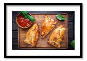 Asian food Samsa or samosas with chicken fillet on cutting board. Top view