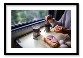 Passenger have lunch in train car by window, travel snack on table. Train meal and tea in glass holder, sandwich lunch in travel, slow living and comfortable journey, onboard snack, window seat