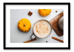 Warm pumpkin spice latte with cinnamon and star anise on a table