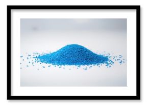 Close-up view of scattered blue EPDM granules on a white surface, perfect for science, art, or material-related themes.