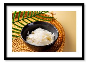 Coconut chips in a bowl. Cocos nucifera.