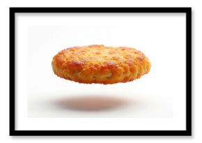 Golden brown fried breaded patty floats mid air over white surface creating shadow. Ready for burger assembly or snack. Minimalist food style.
