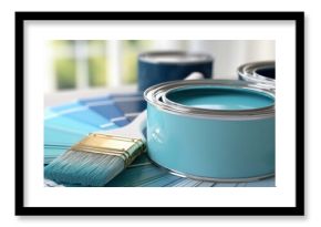 The paint cans and brush with blue swatches for modern home color selection