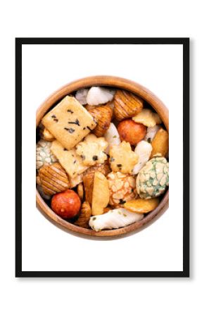 Japanese rice crackers, in wooden bowl. Assorted varieties of Arare crackers made from rice flour, baked and brushed with soy sauce and vinegar to create a smooth texture, some sprinkled with seaweed.