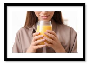 Young woman holding glass of tasty turmeric drink on white background, closeup