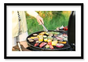 Vegetarian barbeque. Woman cooking vegetables on grill outdoors, closeup