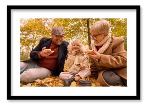 Little girl with father and grandmother sharing laughter while eating pizza outdoors. Concept of family warmth, playfulness, and love for lifestyle, tourism, and food branding visuals.