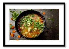 Classic meatball soup with potatoes,  carrot and greens.