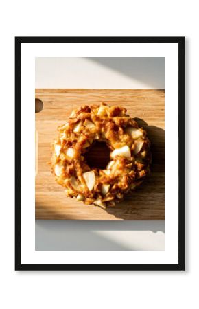 Overhead View of Caramel Glazed Donut Topped with Almond or Coconut Flakes on Wood
