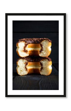 Stack of Two Halved Donuts Showing Layers of Fluffy Dough and Chocolate Filling on Dark Wood